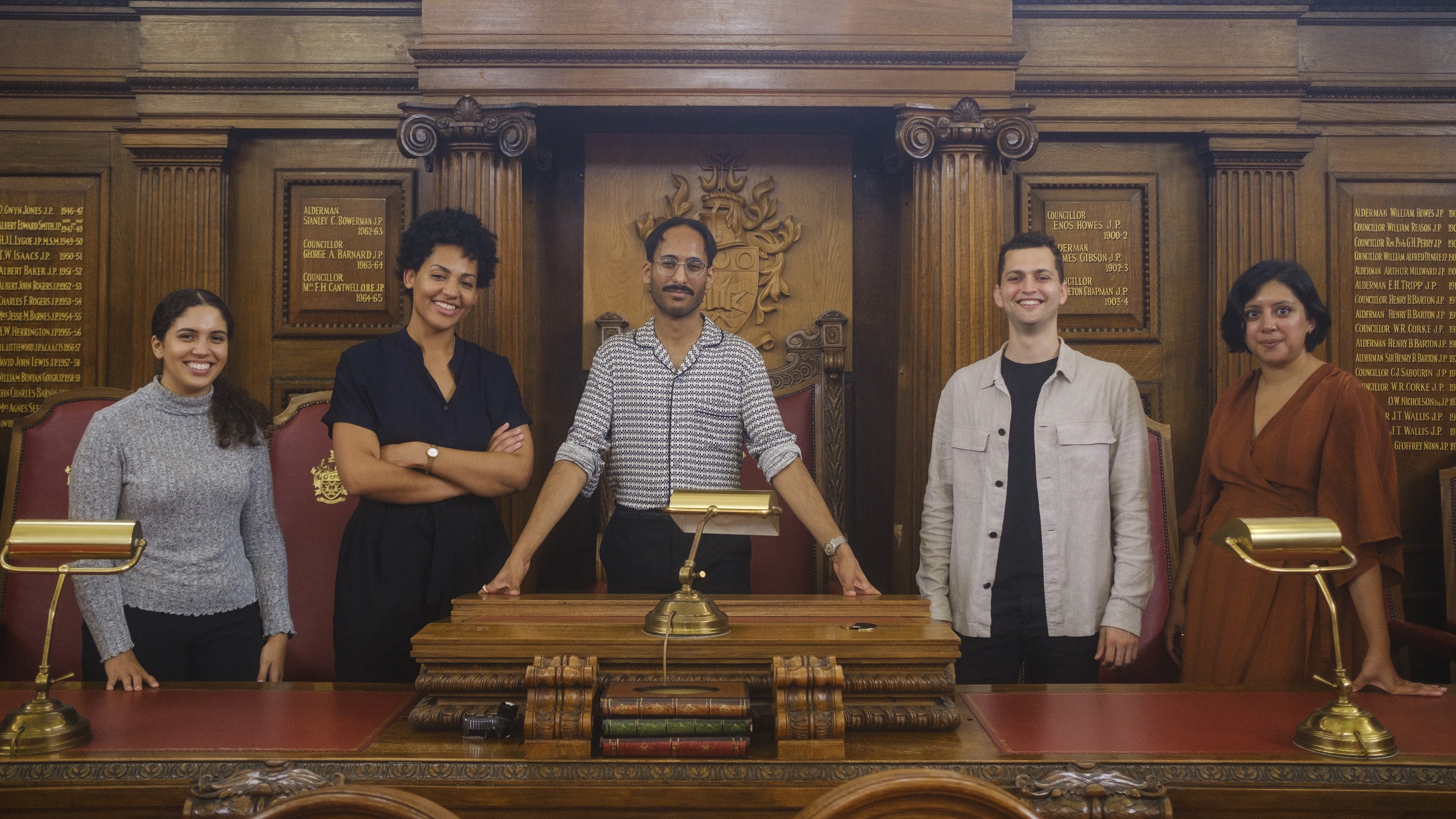 Five NGDP graduates standing in Islington Town Hall council chamber
