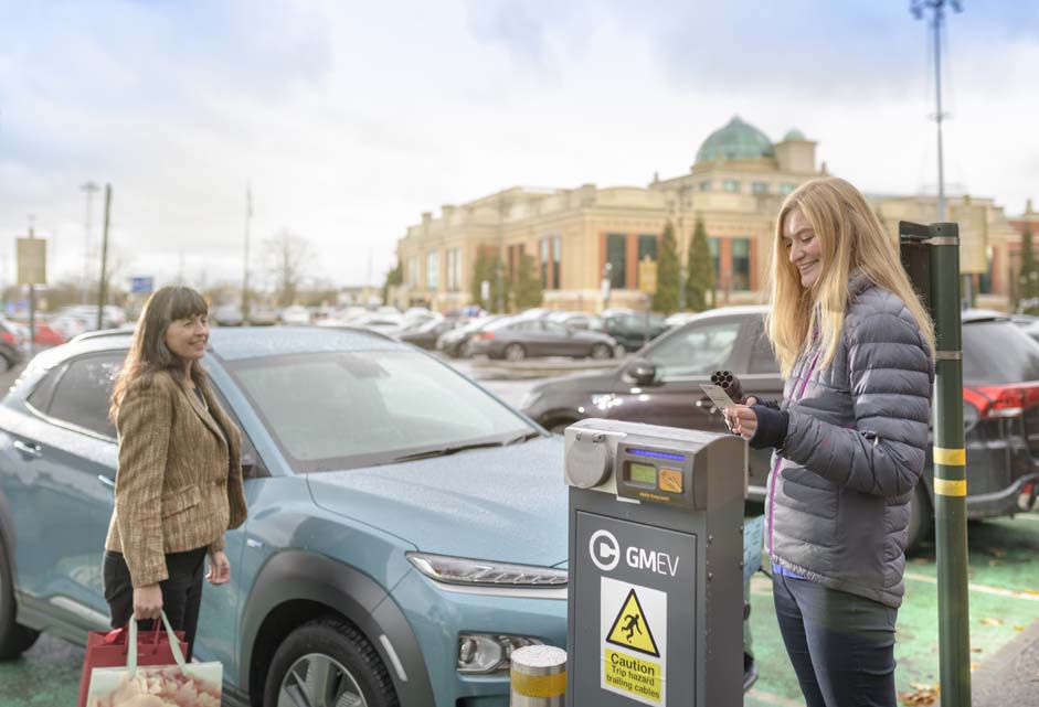 Electric vehicles - women charging cars