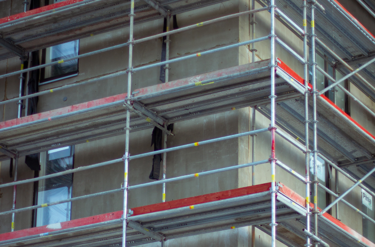 Scaffolding surrounds a high rise building
