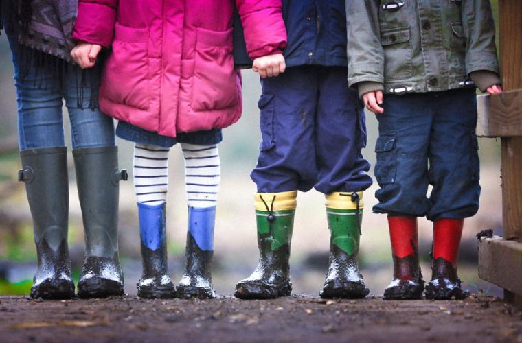 Four children wearing welly boots 941 x 641px