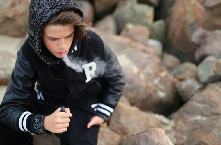 Teenager smoking a disposable vape