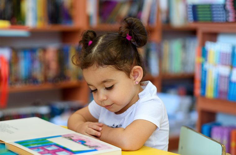 Young girl reading a book 