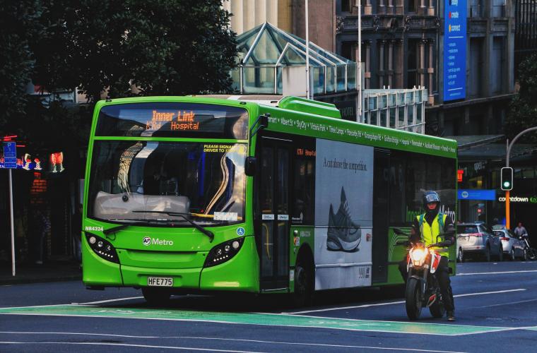 Green bus at traffic lights