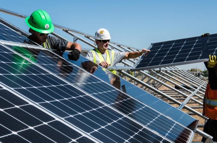Men building a solar panel