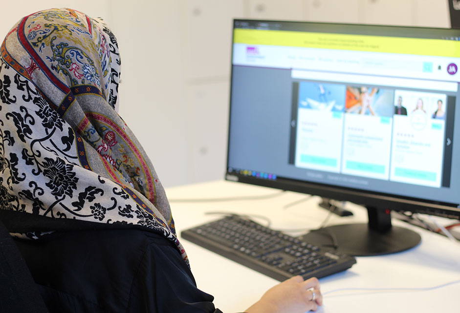 Woman sitting at desk using the LGA's councillor e-learning platform