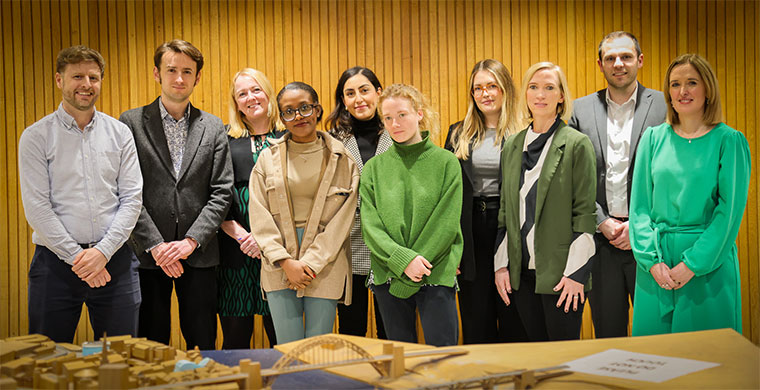 The ten contestants stood together in the council offices