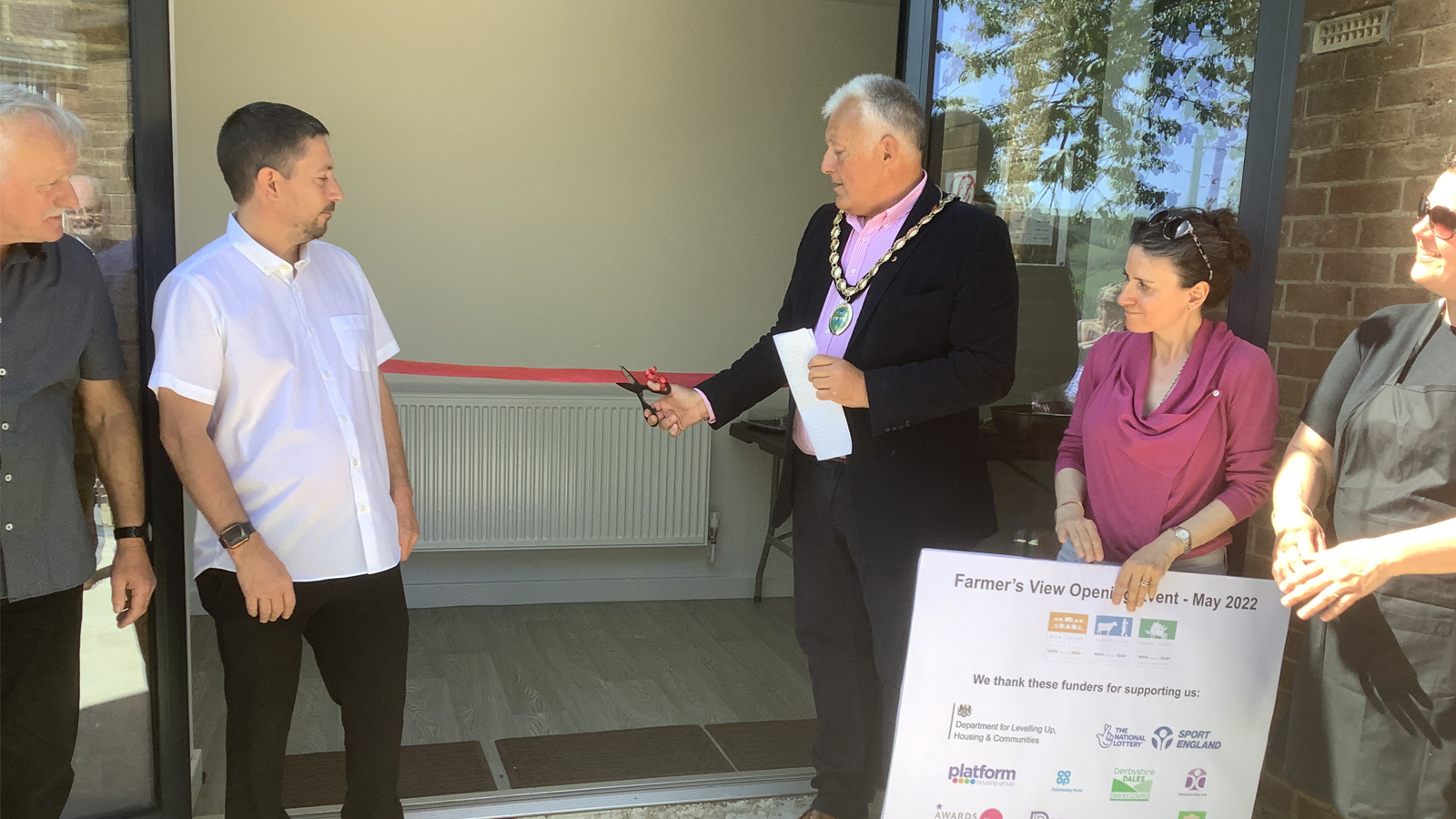 A ribbon being cut at the opening of Hurst Farm Community Hub