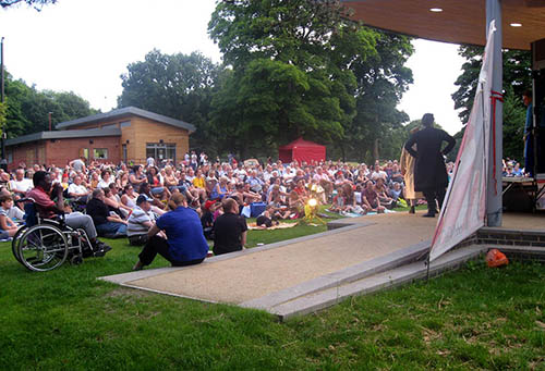 Crowd in park watching performer