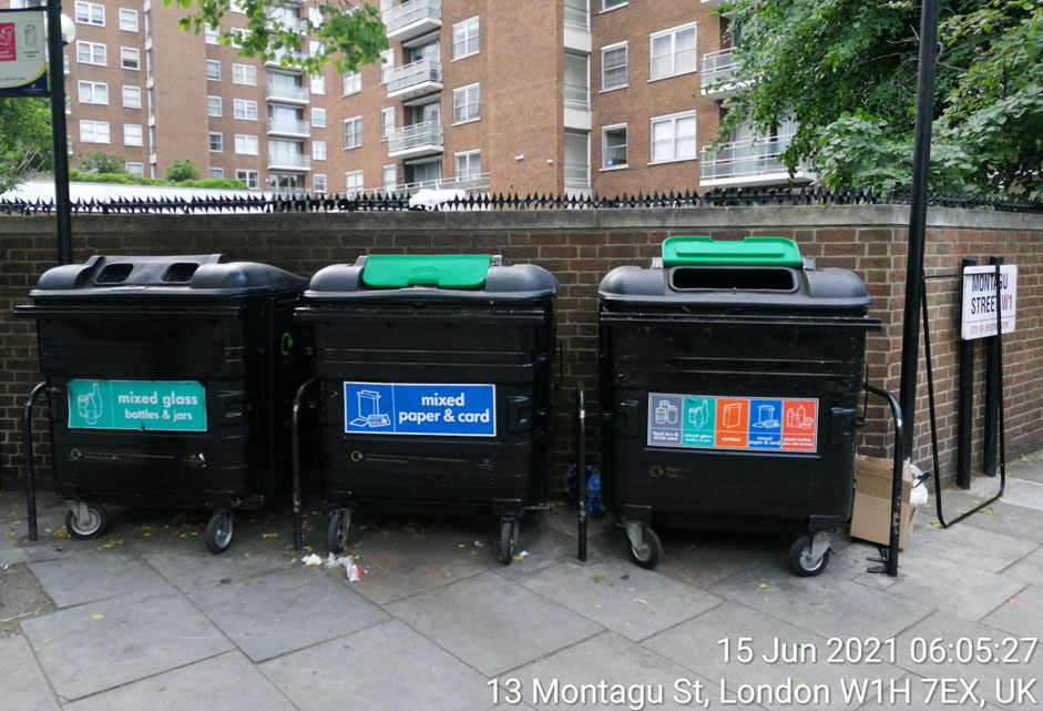 Three black bins on the street 941 x 641px