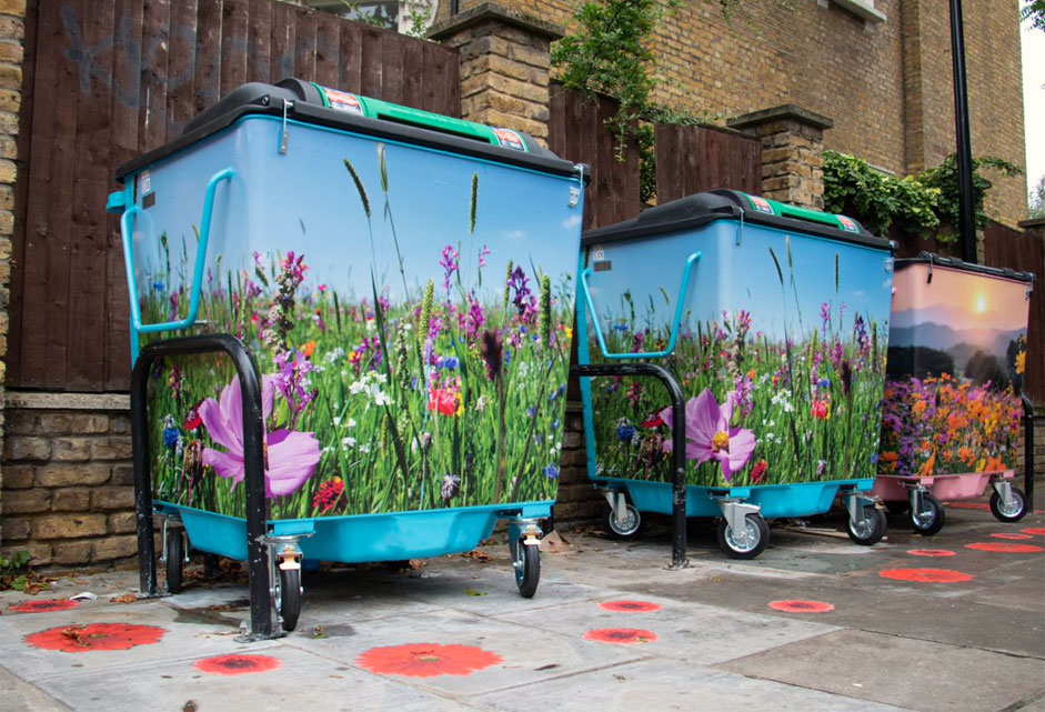 Three bins with flowers painted on them