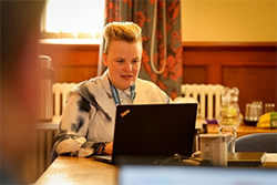Hannah working on a laptop