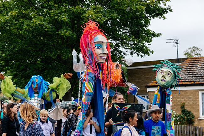 A community parade with 3D artwork