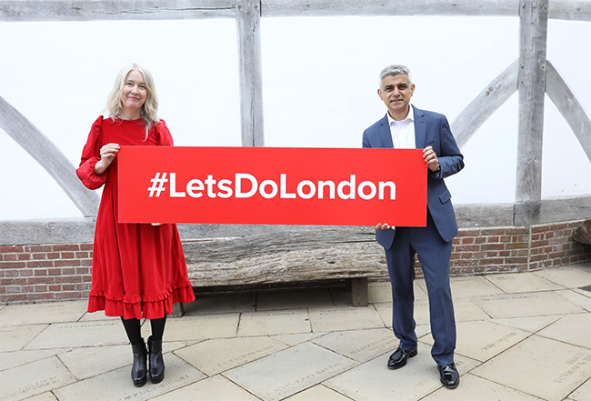 Sadiq Khan and Justine Simons OBE holding a #LetsDoLondon sign in front of Shakespeares Globe