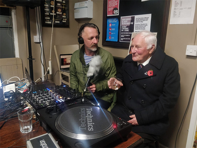 A participant taking part in a live community radio broadcast at The Redhouse Pub