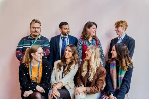 Eight Dorset Council employees aged 18-24 looking at each other and smiling