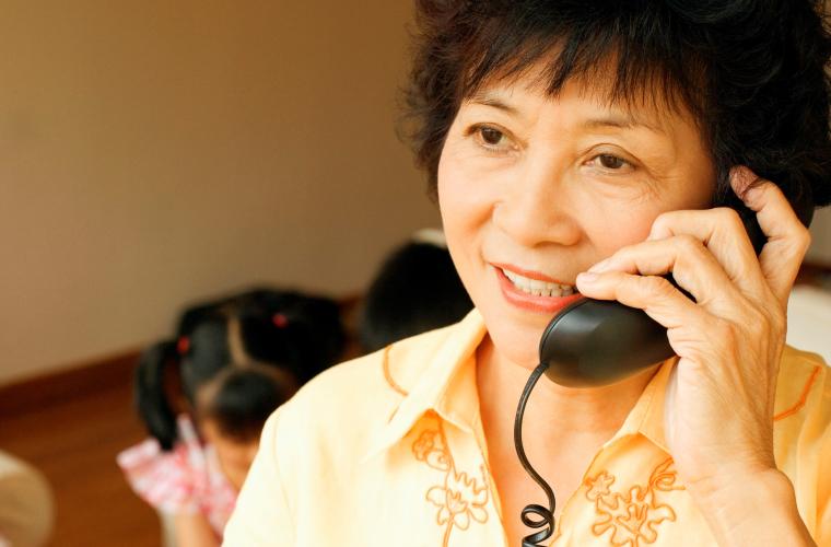 Woman on landline telephone