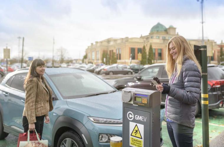 Electric vehicles - women charging cars