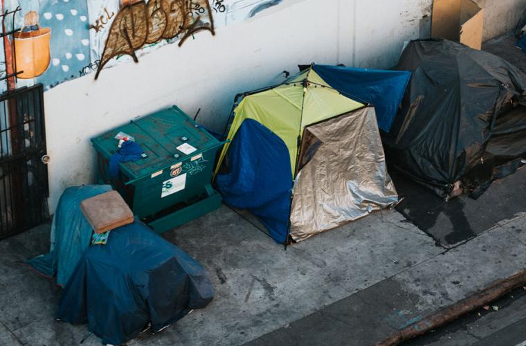 Homeless belongings lined up along the street