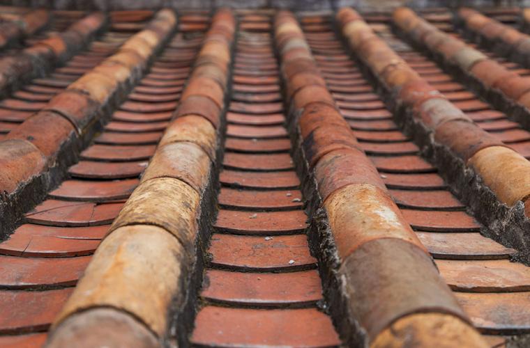 Close-up of terracotta tiled roof requiring repair