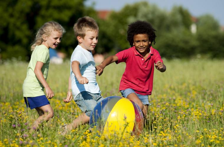 Three children playing in a field