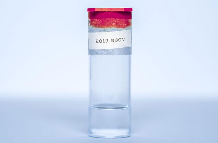 A glass vial with a red lid and a label saying '2019-NCOV'
