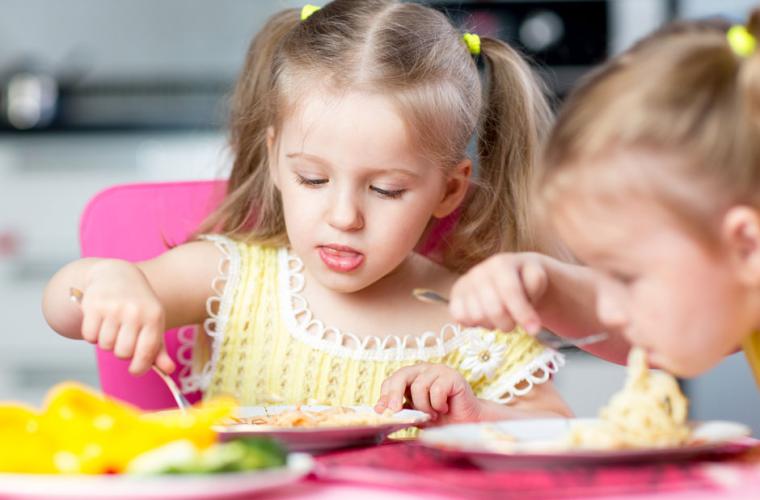 Photo of toddlers eating