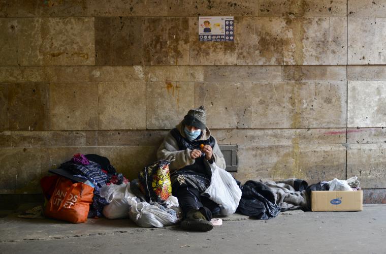 Homeless person in a street surrounded by belongings