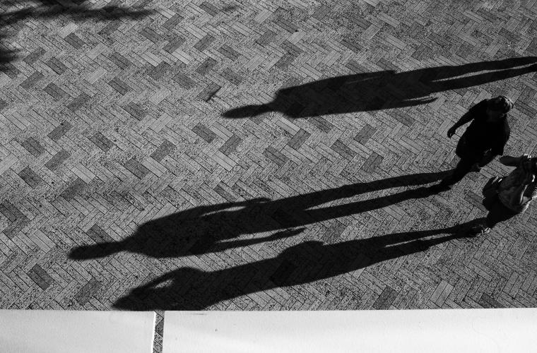 People walking causes a long shadow