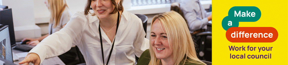 women working behind a screen in an office space
