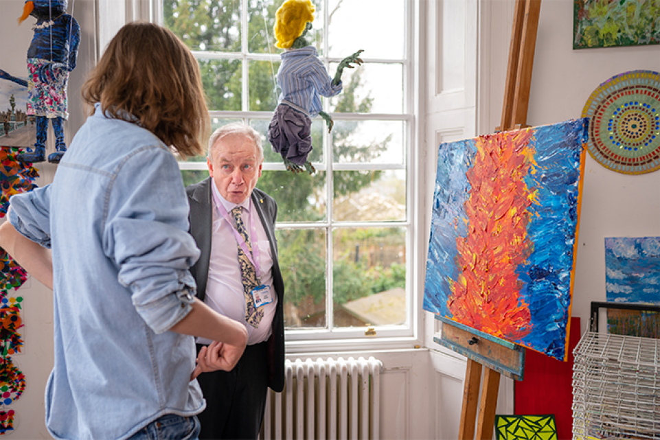 Councillor David speaking to a resident at a community art group