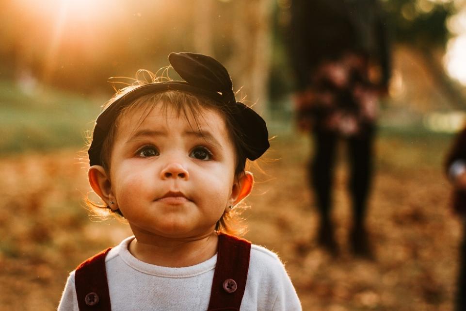 toddler walking wearing black headband